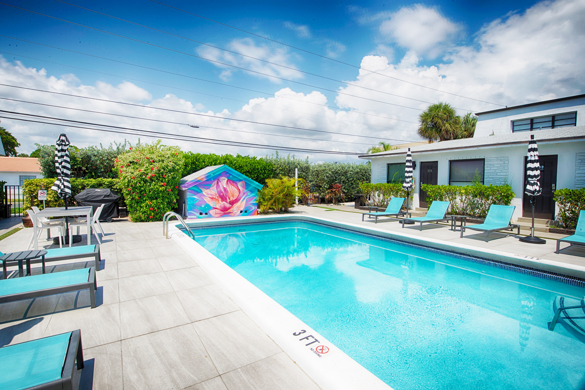 Sunny pool courtyard with signature mural