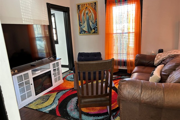 Watch all your favorite shows on a 65" smart tv. If you're chilly there"s a super soft throw and electric fireplace, too!
