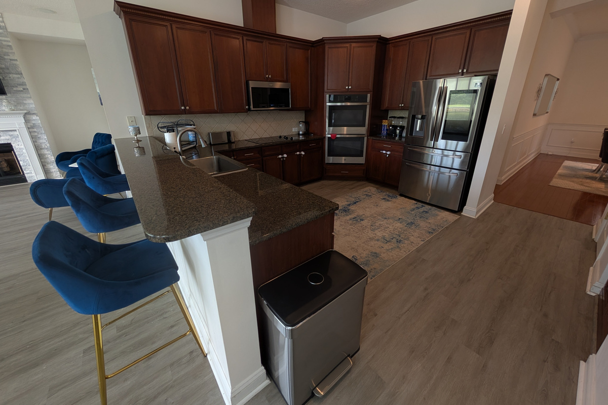 Spacious kitchen with granite countertops, stainless steel appliances, and plenty of room for preparing meals.