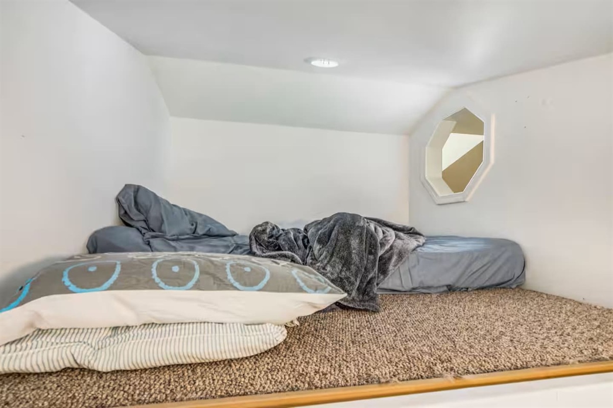 Not the greatest photo, however this is the loft above the bunk beds on first floor. This is a open window that over looks the living room. Great for a older child. No safety rails present at the moment. Only use this area at your own risk. 