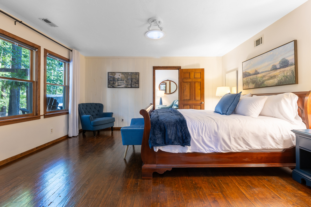 The lower level bedroom features a king bed with plenty of space for reading in a comfy chair or relaxing. Enjoy the wooded view while you lay in bed. 