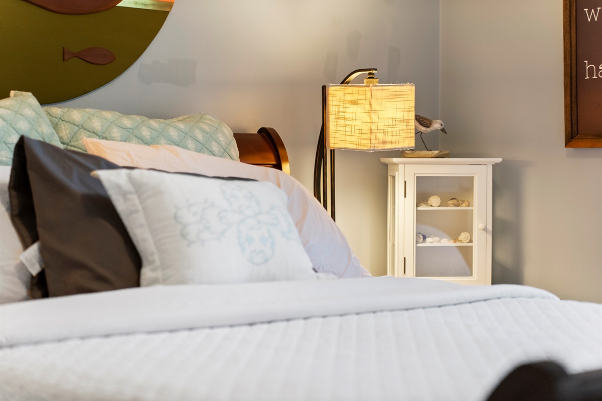 Queen room with ocean themed decor.