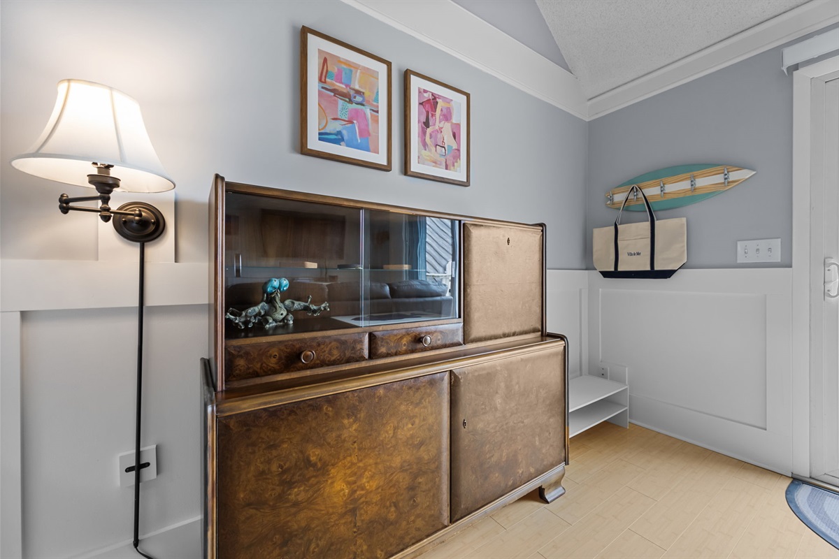 Thoughtful coastal touches and vintage accents add character and warmth throughout the living room