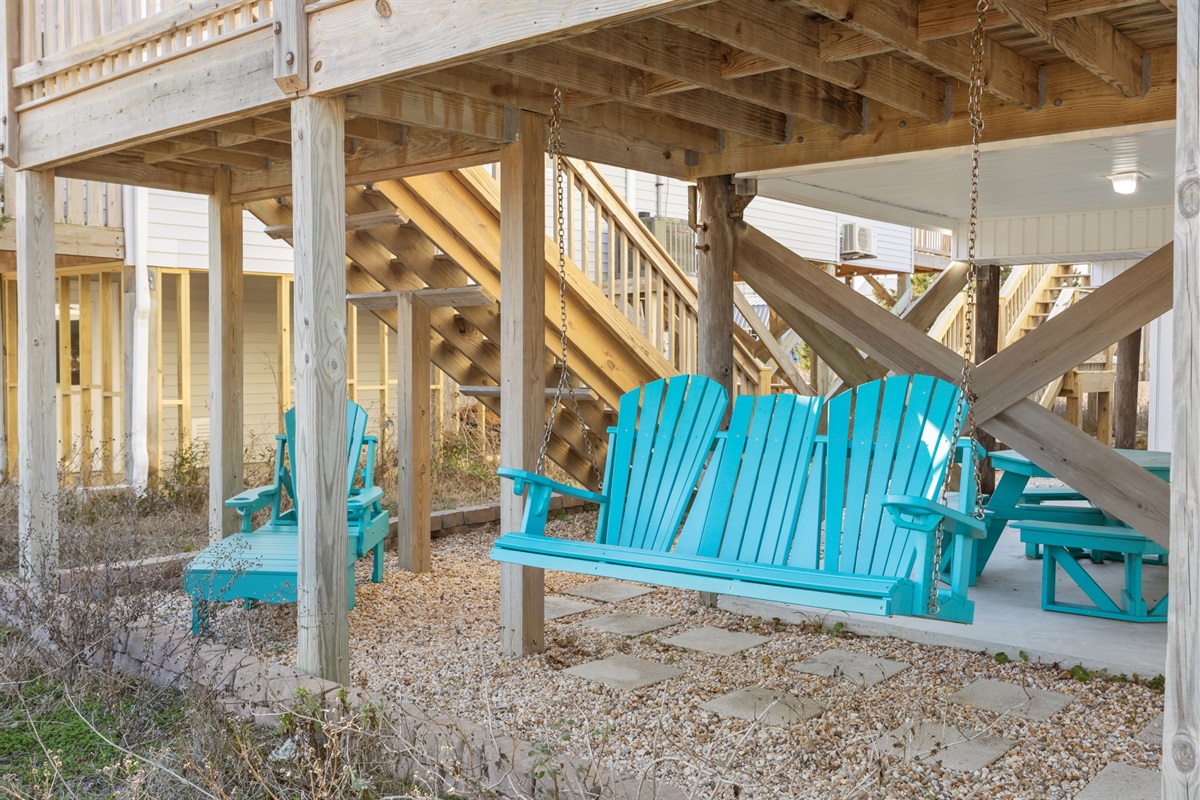 Relaxing swing seating under the deck for laid-back coastal vibes
