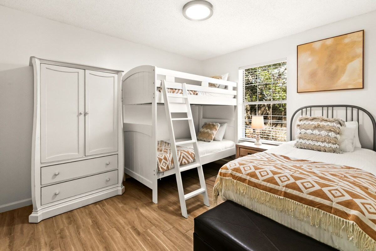 Guest room with a twin over twin bunk bed and a single twin bed