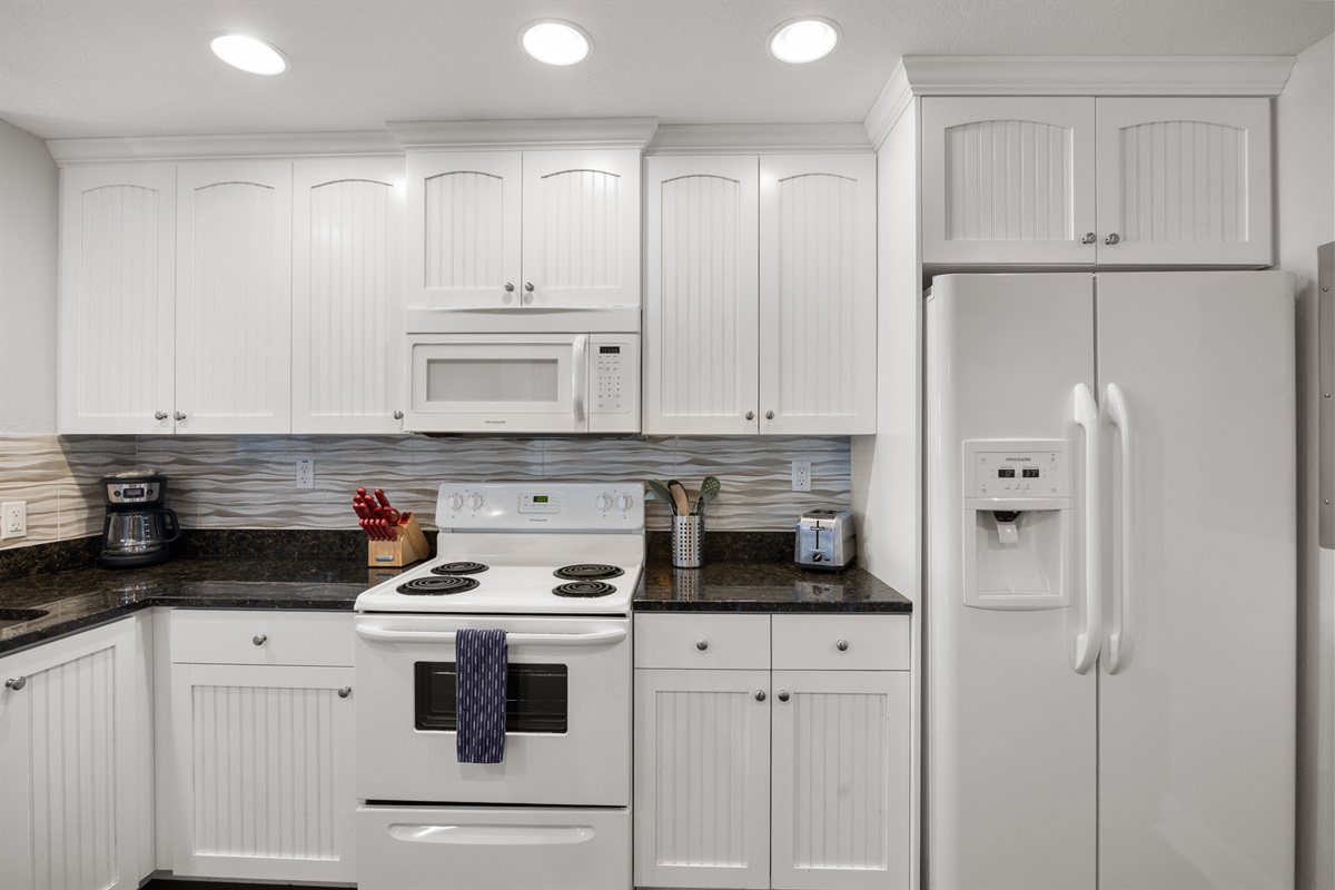 Kitchen, fully stocked with cooking/eating/drinking utensils