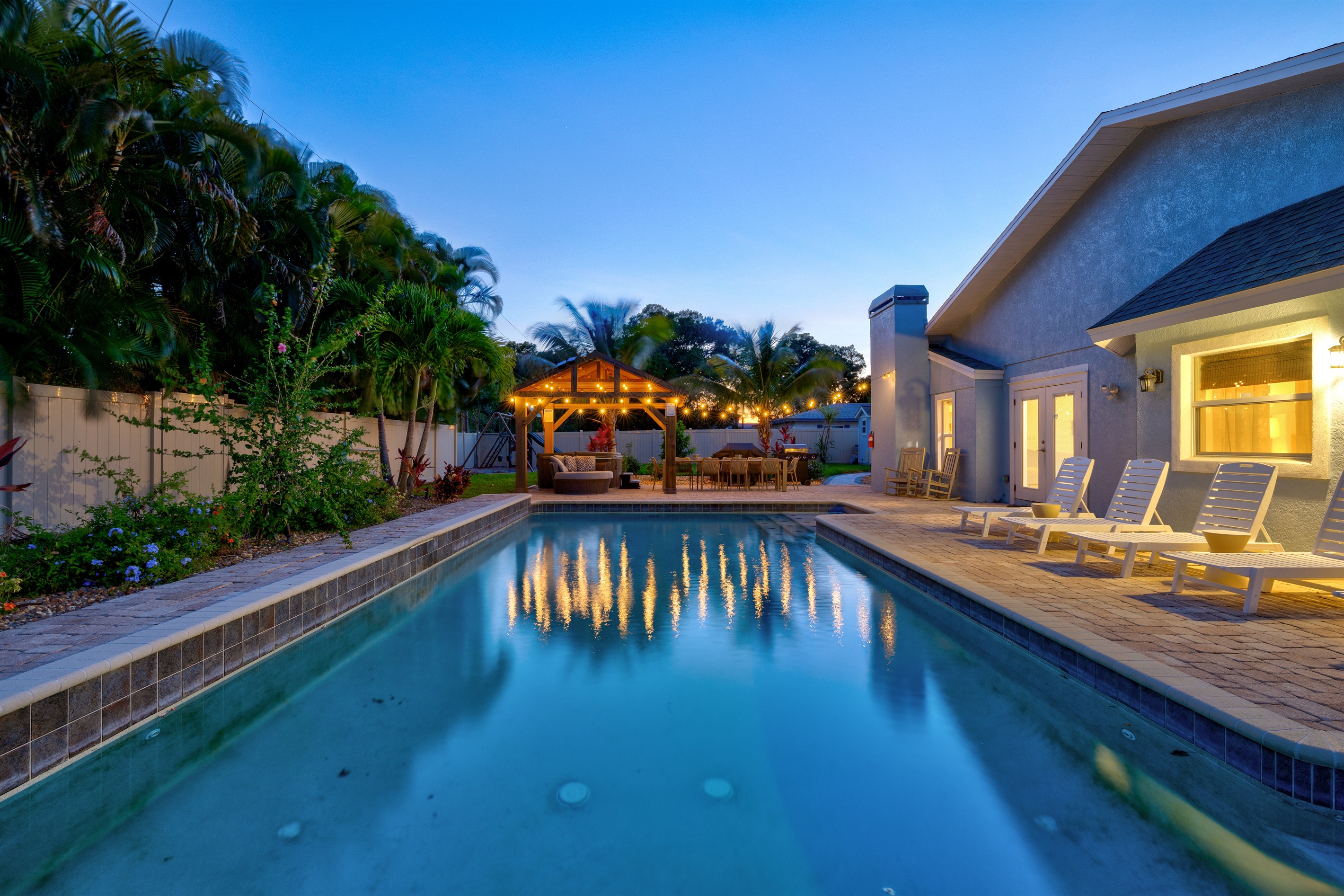 Welcome to Royal Palms, your private slice of paradise. As twilight falls, the pool sparkles, the hot tub invites you to relax, and the outdoor dining area becomes the perfect spot to enjoy a magical evening under the stars.