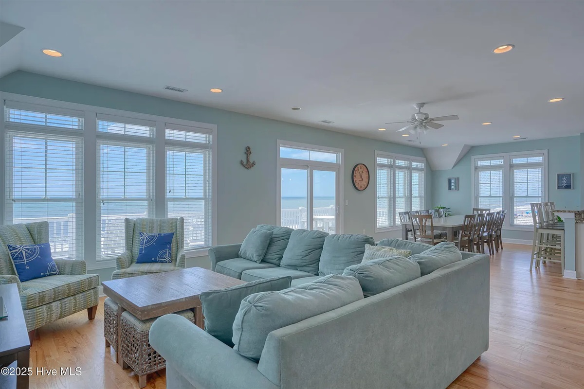 Expansive living area with panoramic coastal views through every window