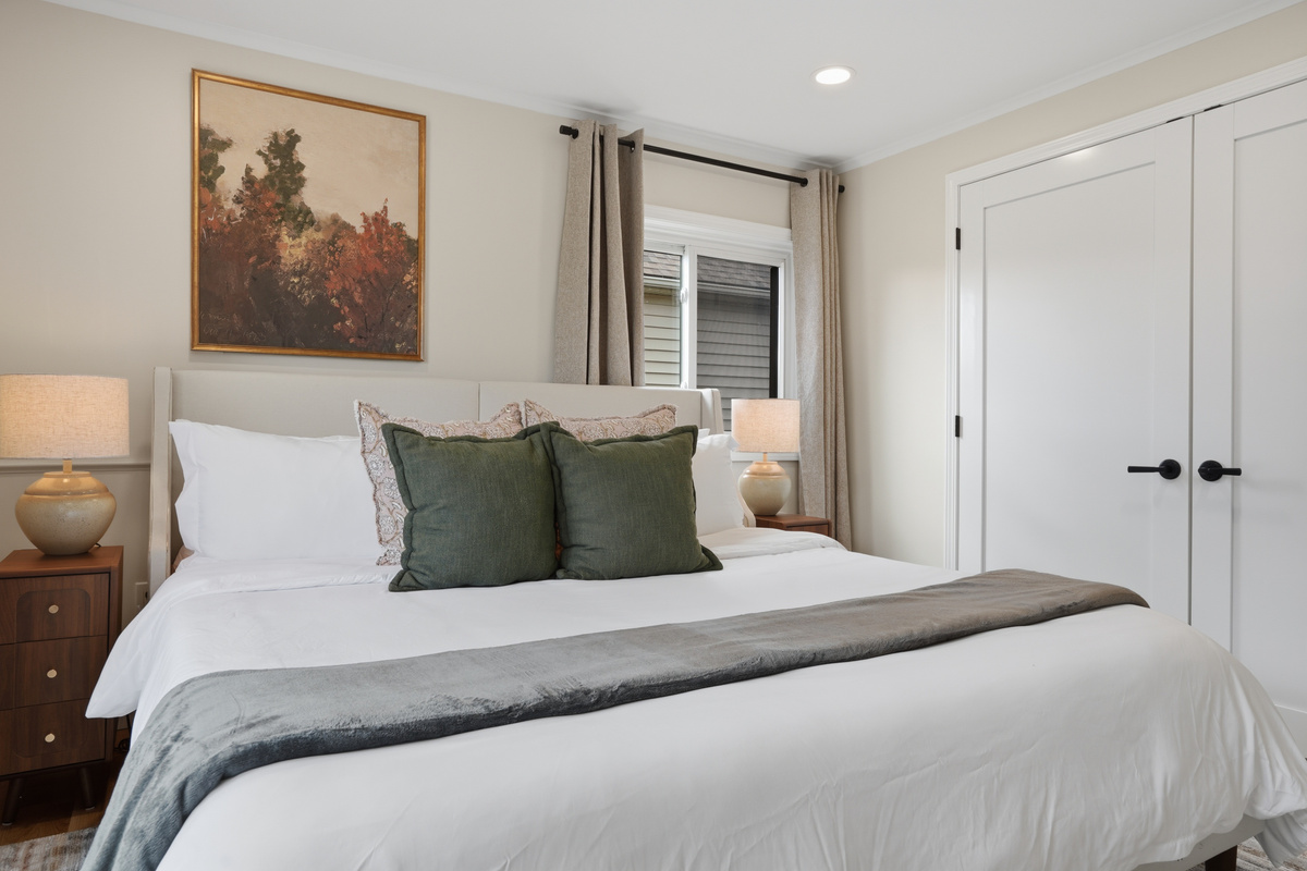 Bright and cozy bedroom with a king bed, soft neutral décor, and warm natural lighting. Clean, comfortable space designed for a restful and relaxing stay.
