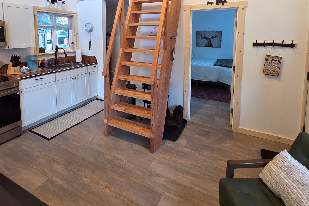 Main floor area.  Bedroom is to the right front.  Bathroom and laundry are to the right rear.  Ships ladder access to the loft living area and additional sleeping space [Photo is representative but is not from this cabin].