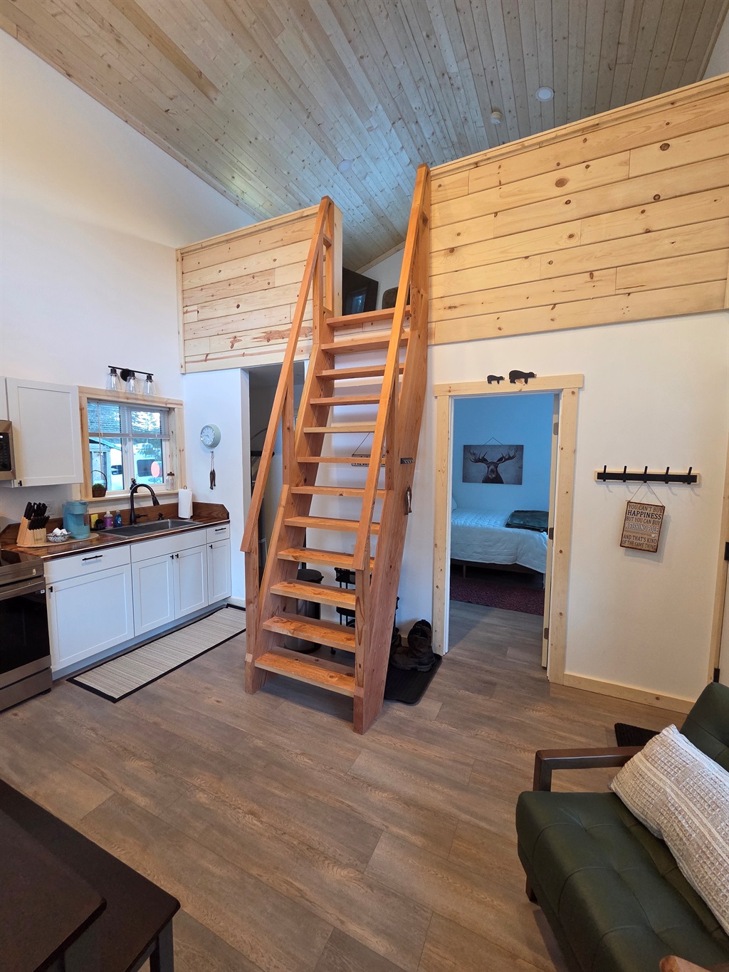 Main floor area.  Bedroom is to the right front.  Bathroom and laundry are to the right rear.  Ships ladder access to the loft living area and additional sleeping space [Photo is representative but is not from this cabin].