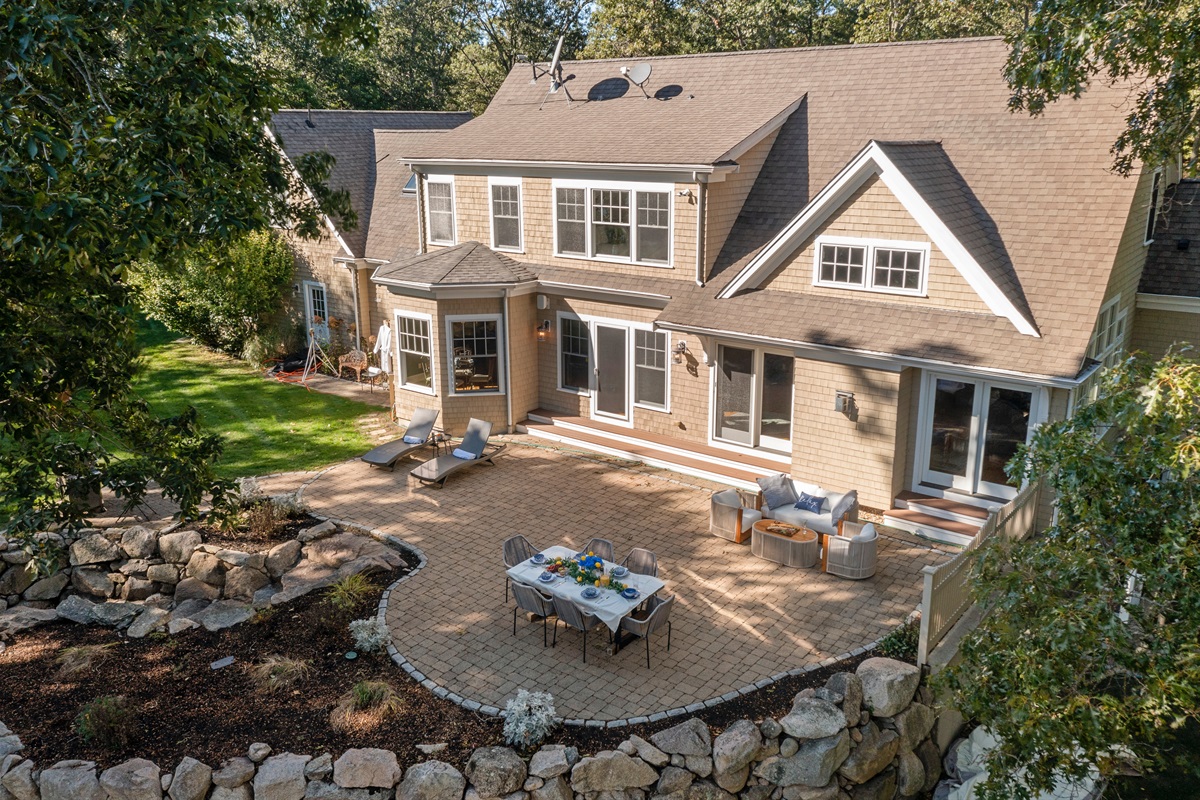 A full layout of lakeside living—grill, firepit, seating, and the water just steps away.