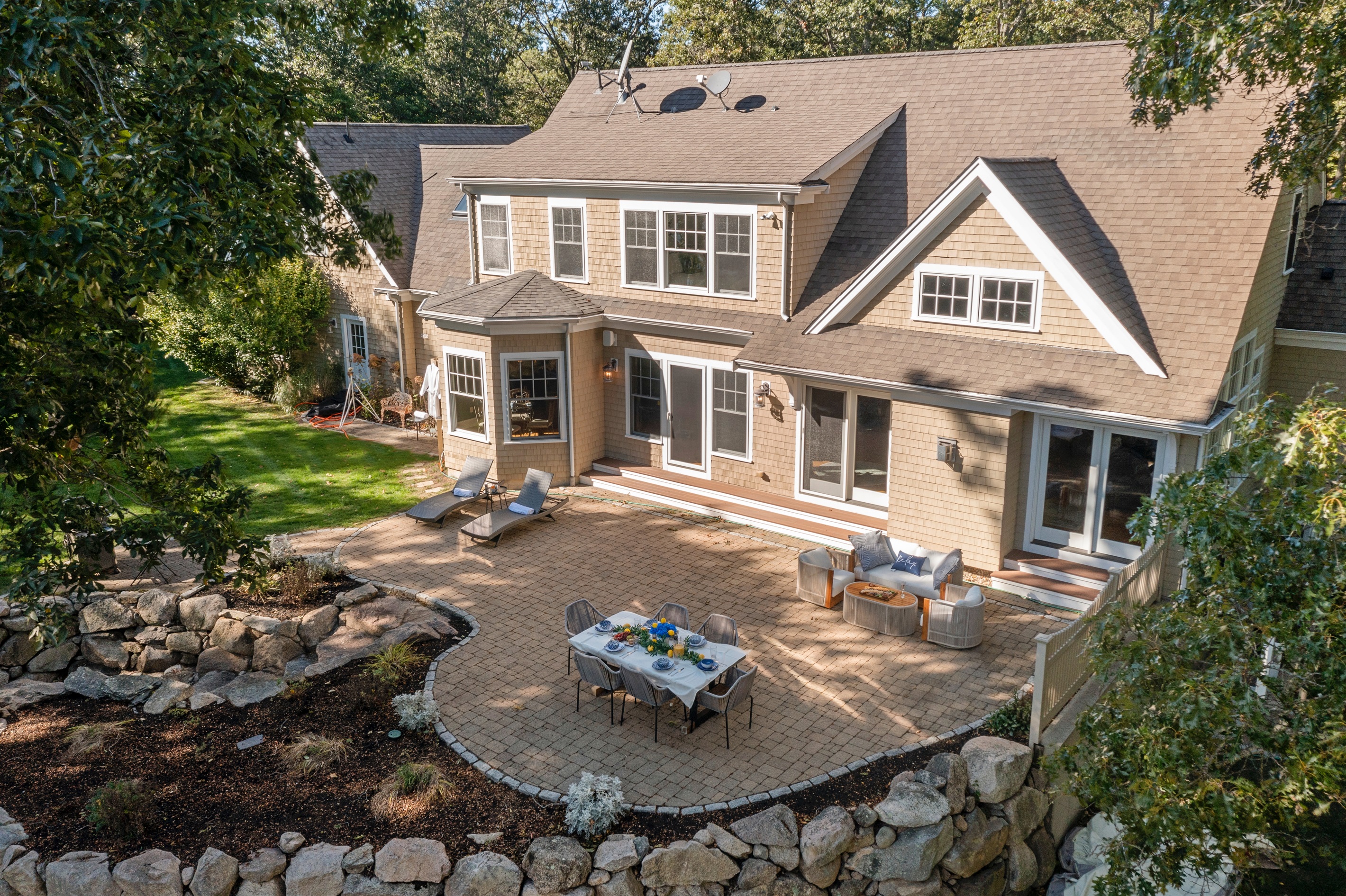 A full layout of lakeside living—grill, firepit, seating, and the water just steps away.