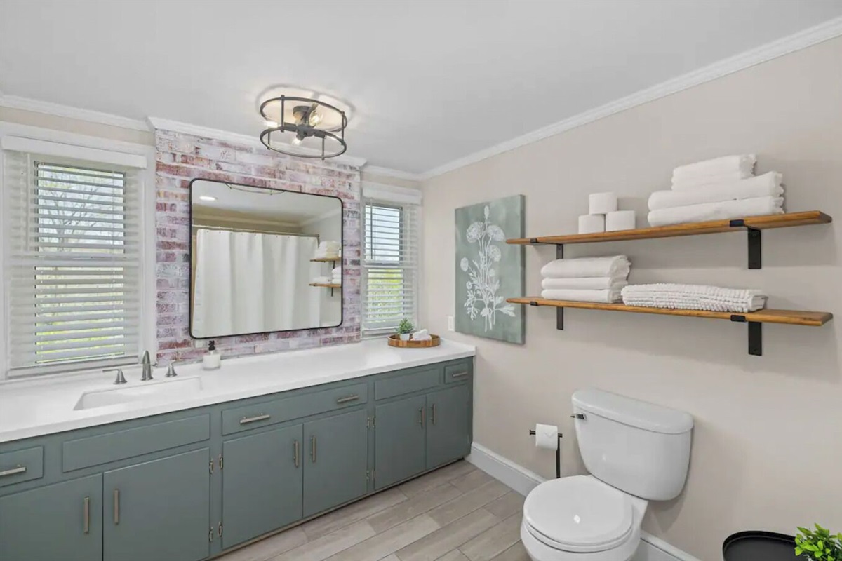 Full bathroom in the Oak Canopy Suite includes sink, toilet, & tub/shower.