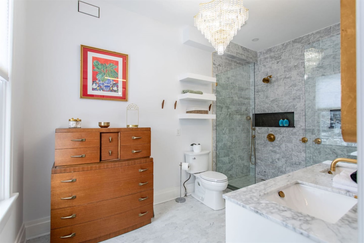 A full bathroom equipped with a shower or bathtub, a toilet, and a vanity with a sink, providing all the essential amenities for comfort and convenience.