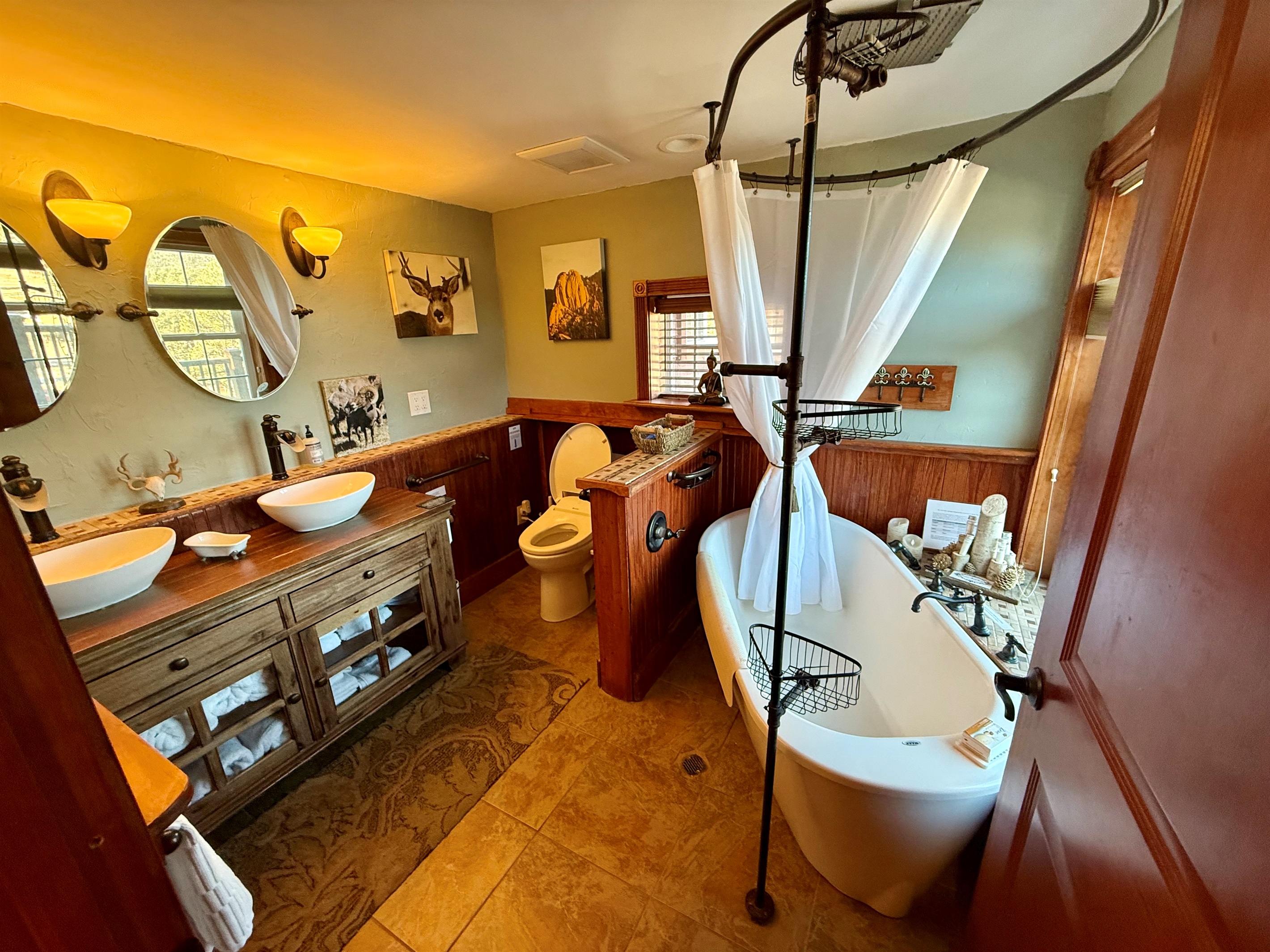 Spacious main bathroom with double sinks, soaking tub, and heated floors for cozy mountain mornings.