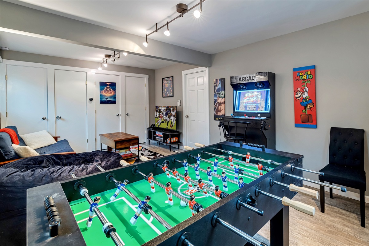Pocono mountains rental | The game room is a fun-filled space with a foosball table, PS4, TV, darts, arcade games, and a variety of board games, perfect for entertainment and relaxation