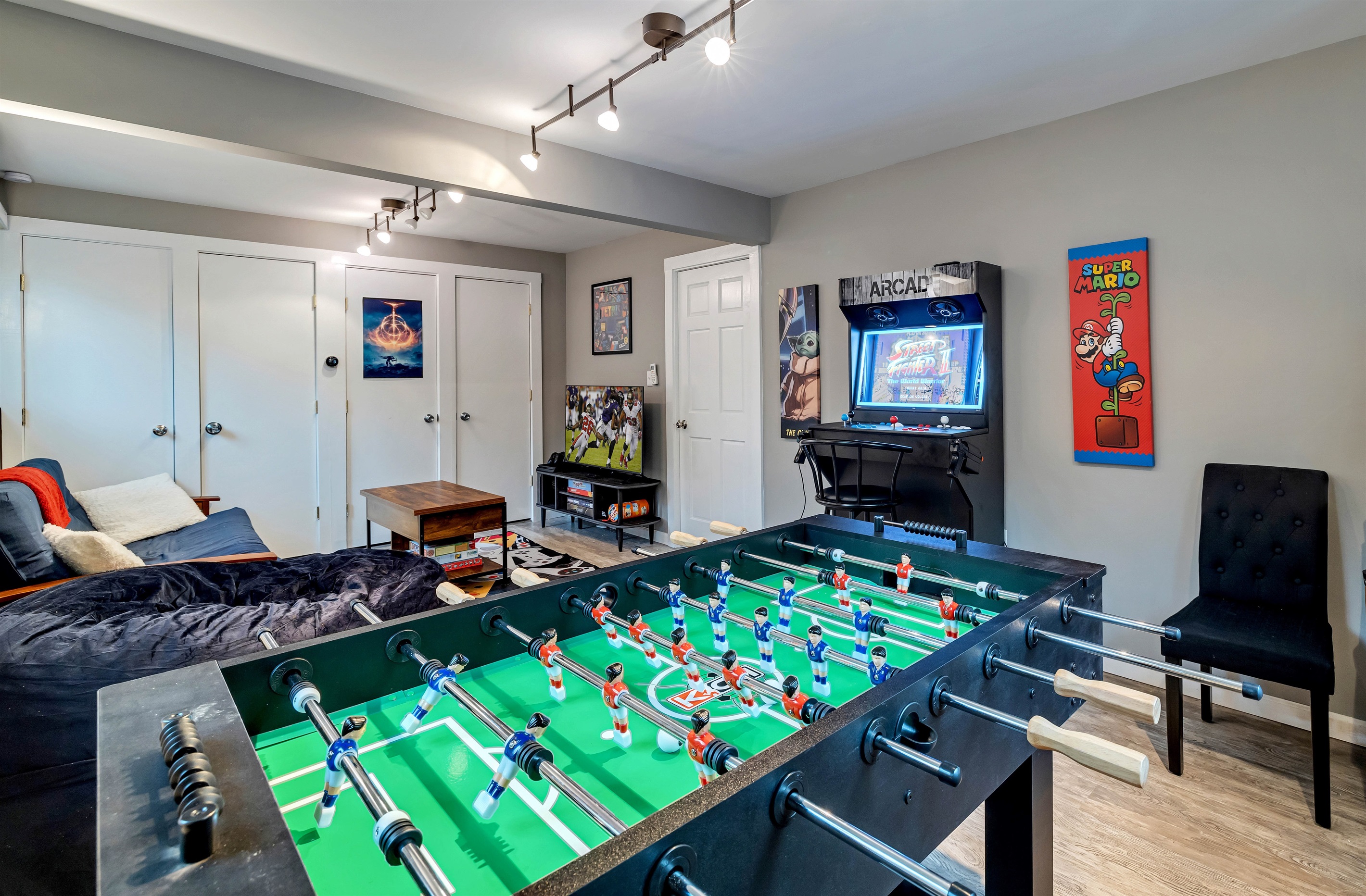 Pocono mountains rental | The game room is a fun-filled space with a foosball table, PS4, TV, darts, arcade games, and a variety of board games, perfect for entertainment and relaxation