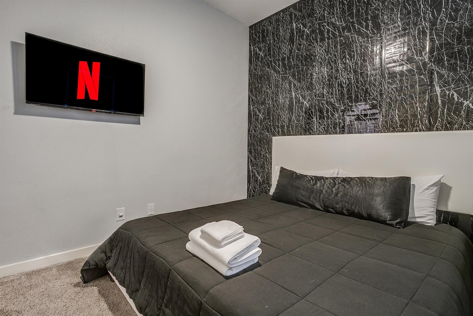 Comfortable bedroom with Smart TV + Netflix ready for movie nights.