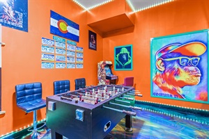 A playful oasis filled with bright orange hues and exciting entertainment options, from pool, airhockey, beerpong and foosball to arcade classics, making this the ultimate spot to unwind and have fun.