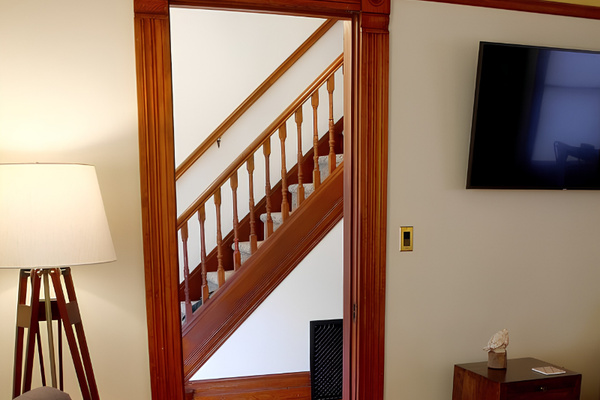 Hall next to living area leads guests to the original historic staircase leading to the upper level bedrooms