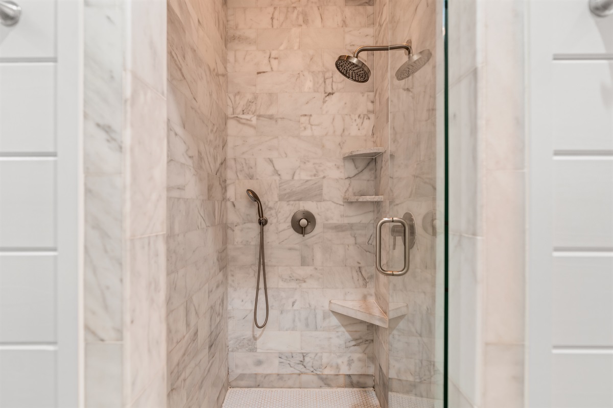 Enjoy a spa like shower surrounded by marble in the master bath.