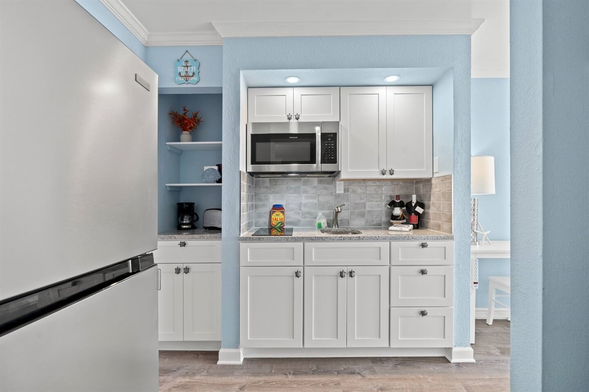 Recently updated kitchenette area provides a 2-burner stove, microwave, full fridge/freezer and shelving for coffee and other useful appliances --perfect for enjoying some meals and mixing up cocktails!