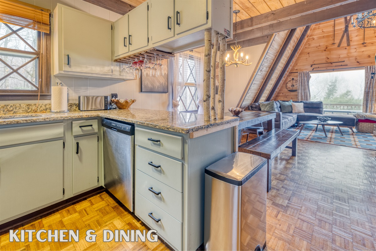 The fully equipped kitchen with granite countertops and stainless steel appliances adjoins a welcoming dining area, ideal for family meals and gatherings.