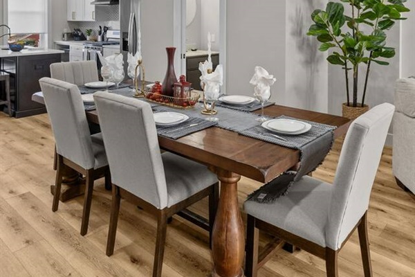 Large dining table with seating for 6-7 (4 chairs and one long bench).
