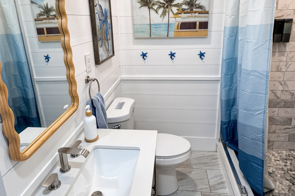 Hall bathroom with walk-in shower and laundry 