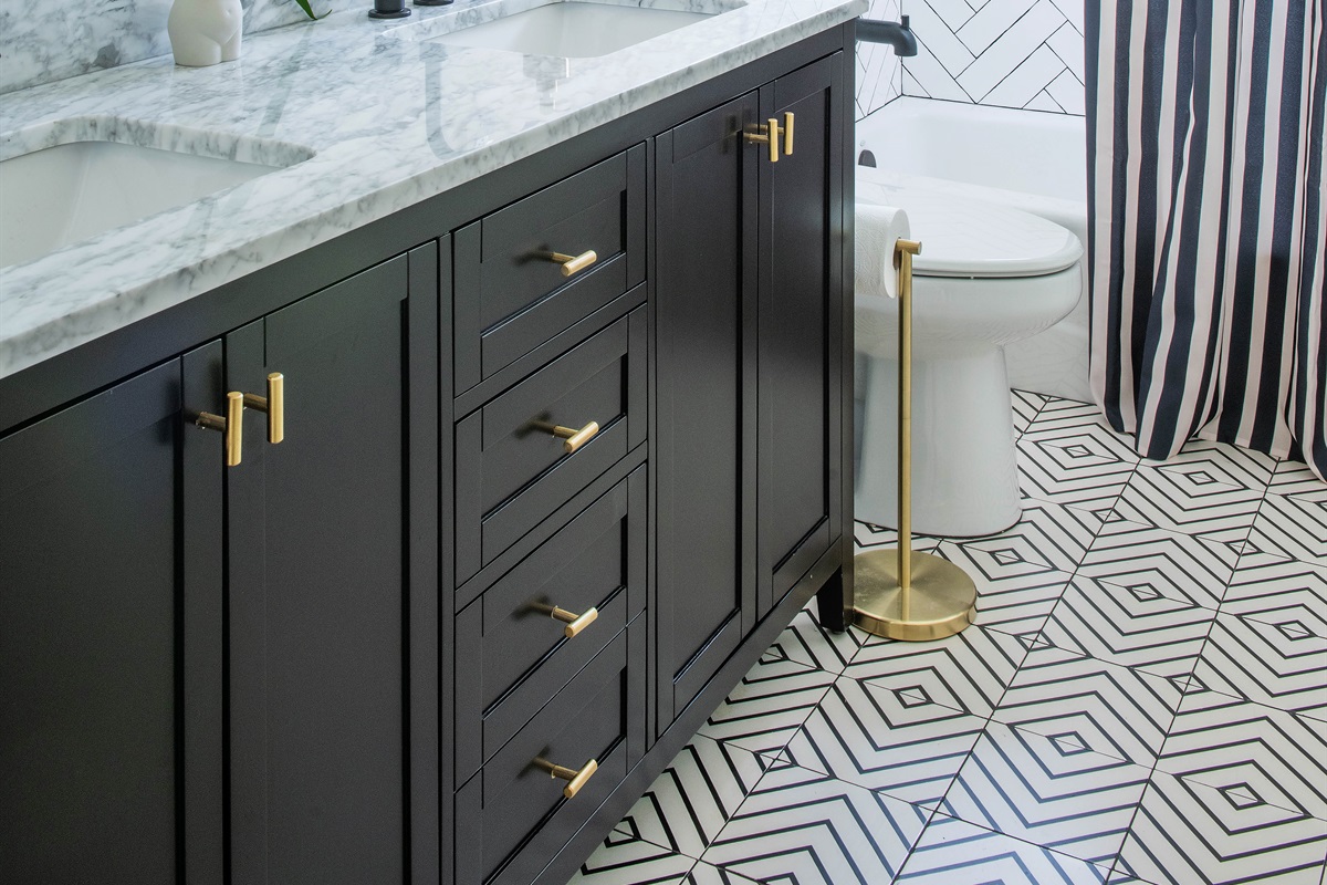 Shared guest hall bath with sleek design and double vanity