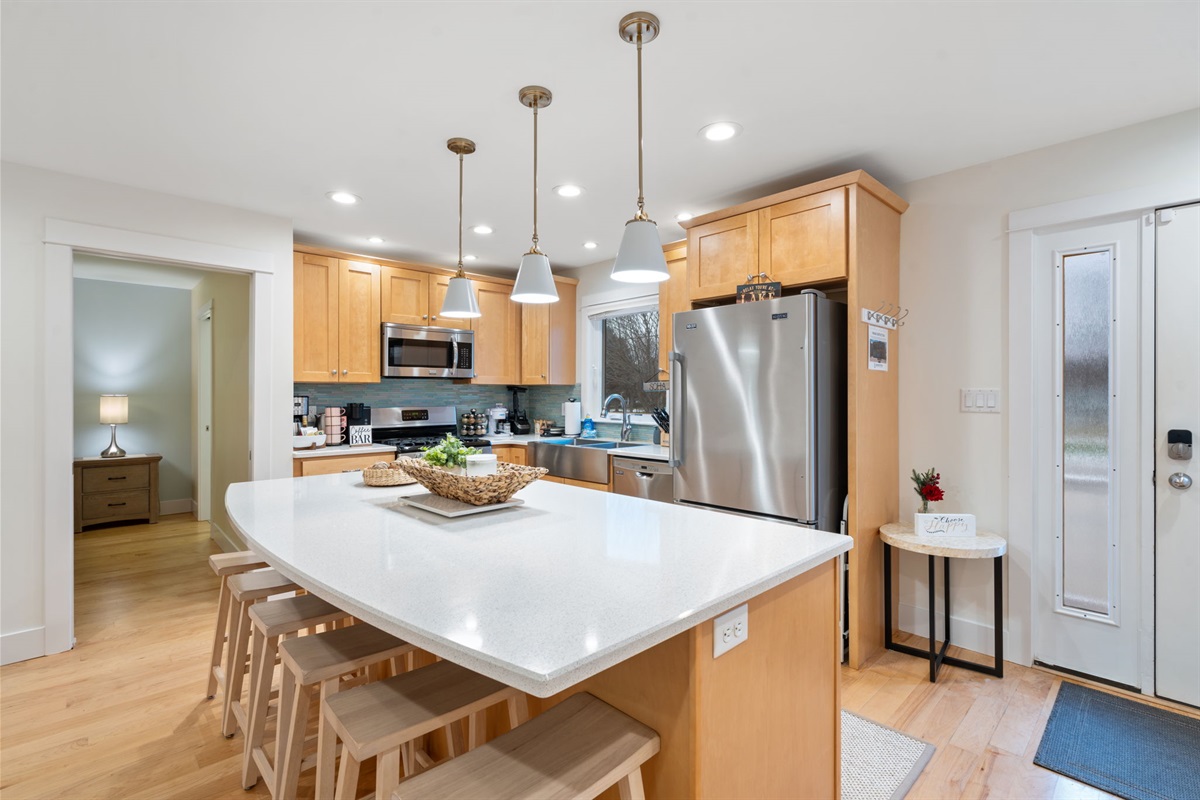 The kitchen space with a huge island and plenty of counter space and seating