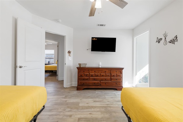 The second bedroom with a 43-inch Roku TV, and you can see the dedicated kid's playroom to the right.  Roku TVs allow you to view your own streaming shows and will log you out automatically when you leave.
