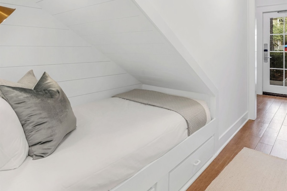 The cutest twin bed with storage in the hallway