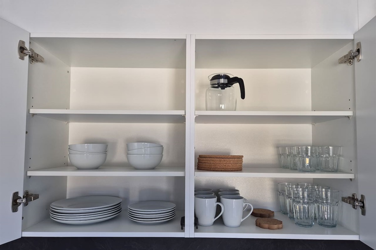 The kitchen comes equipped with plenty of plates, glasses and other daily necessities