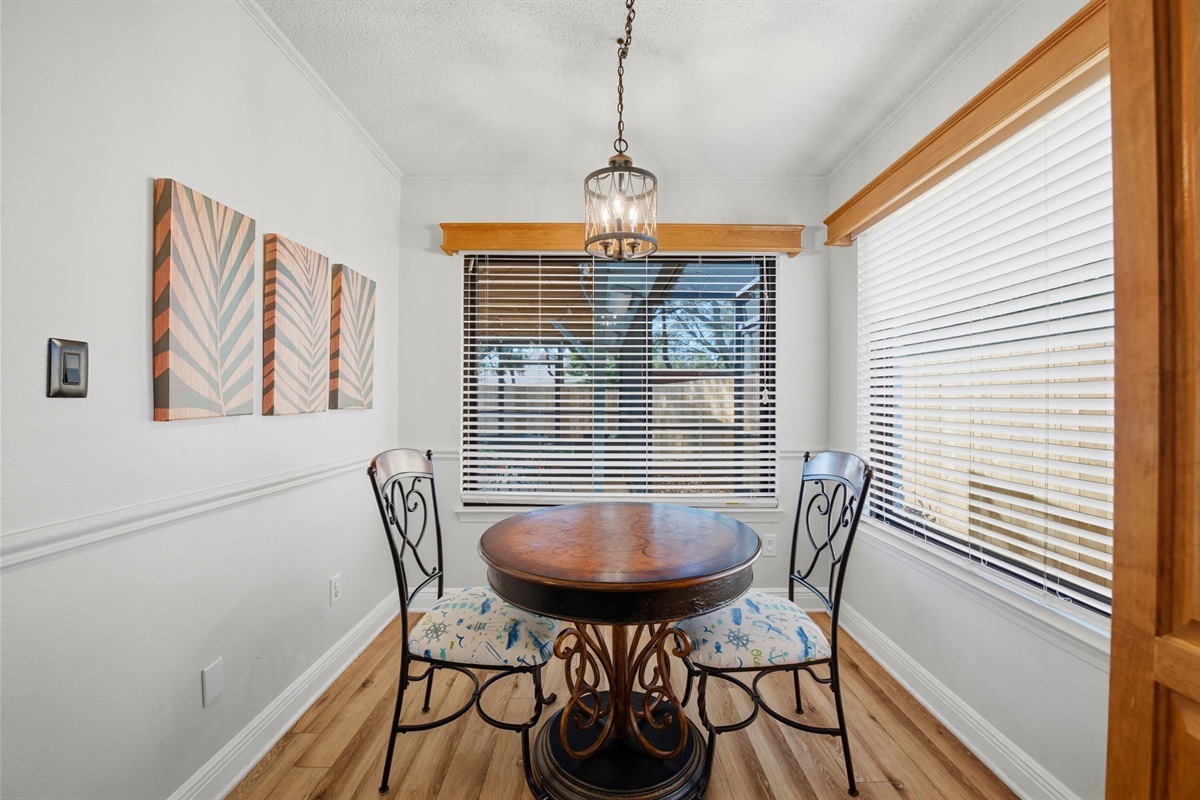Enjoy meals in this bright dining area featuring a stylish round table and comfortable seating for two. With large windows overlooking the outdoor space, it’s a peaceful setting to start your day or relax with a casual dinner.
