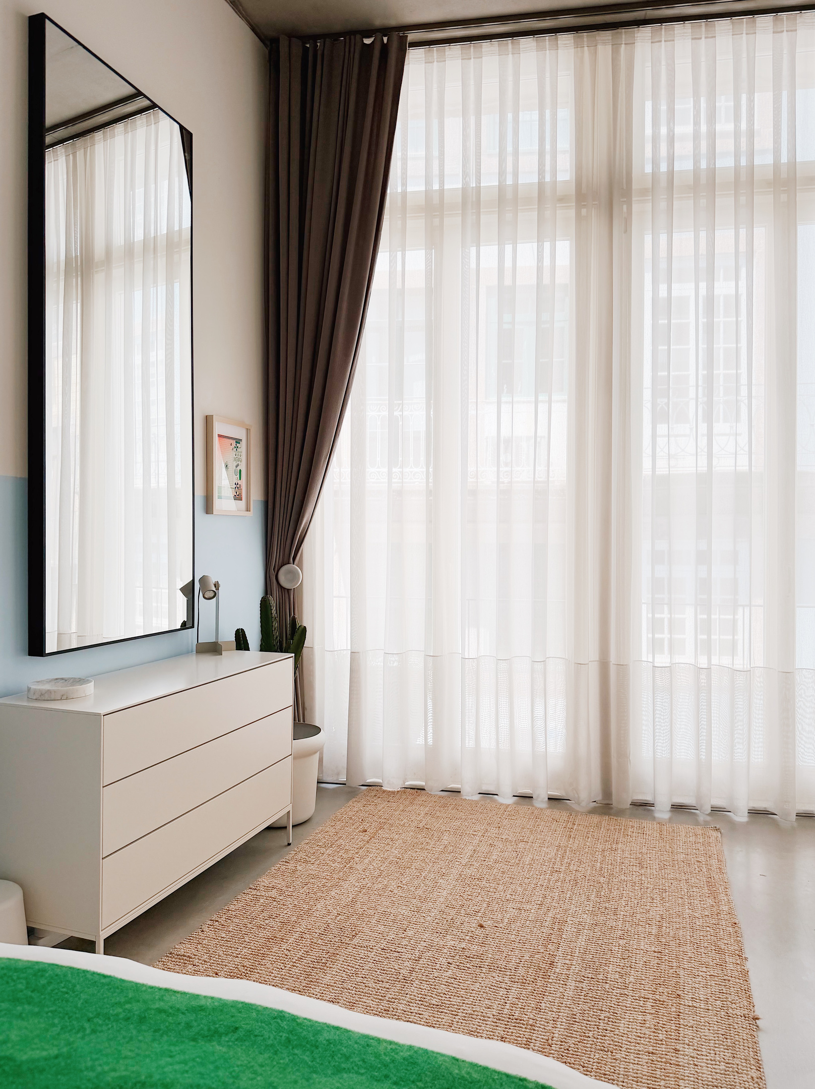 Bedroom with full dresser and privacy sheers.