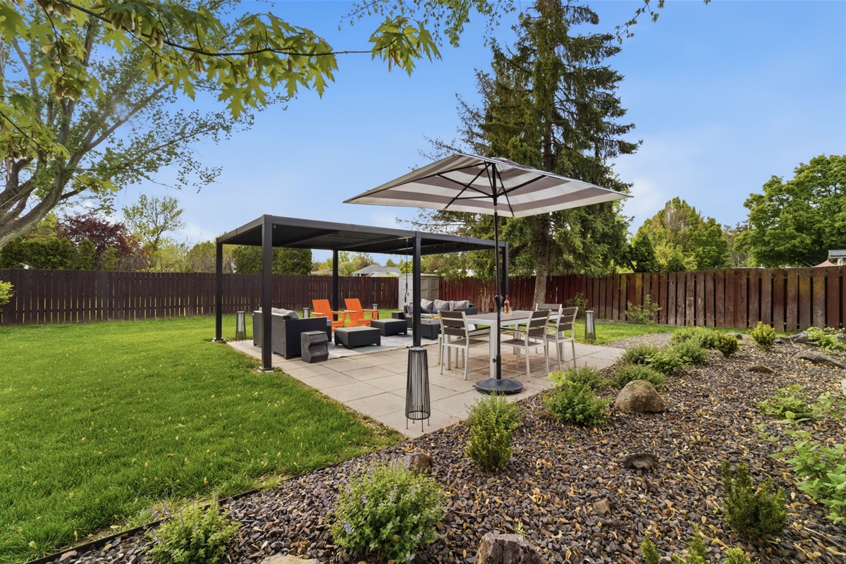Patio area w/ dining table. covered lounge area.