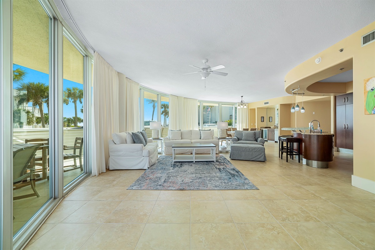 Experience the epitome of coastal living in this beautifully designed living room. Featuring plush furnishings, a serene color palette, and expansive views, this space offers a tranquil retreat for residents and guests alike.