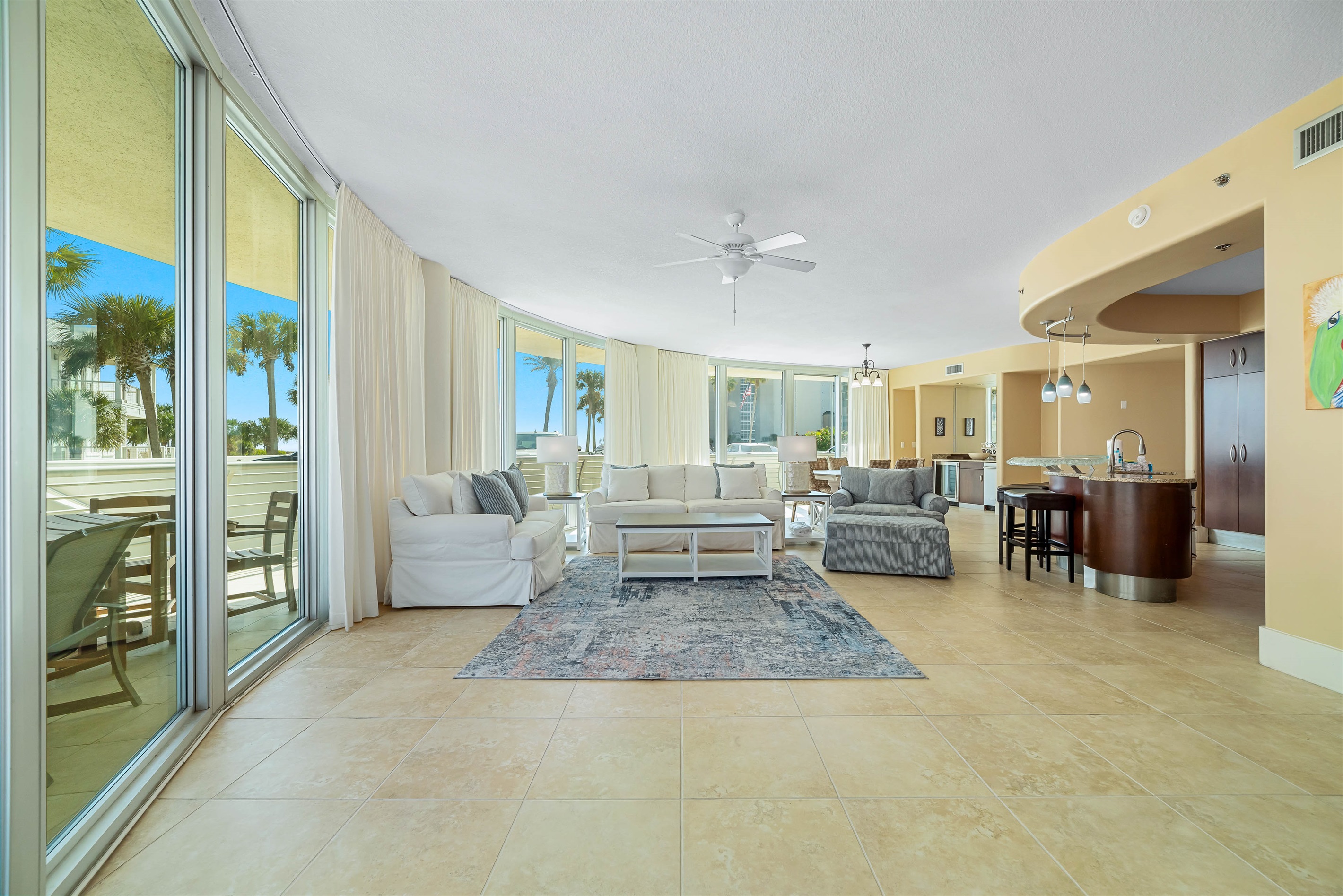 Experience the epitome of coastal living in this beautifully designed living room. Featuring plush furnishings, a serene color palette, and expansive views, this space offers a tranquil retreat for residents and guests alike.