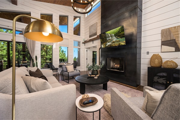 Light-filled Great Room with soaring windows, cozy textures, and fireside relaxation