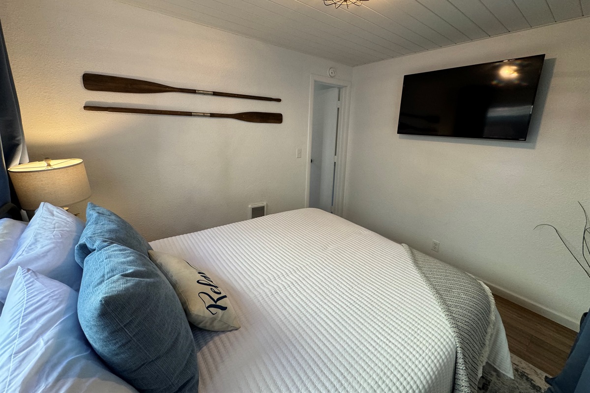 queen bedroom with its own TV