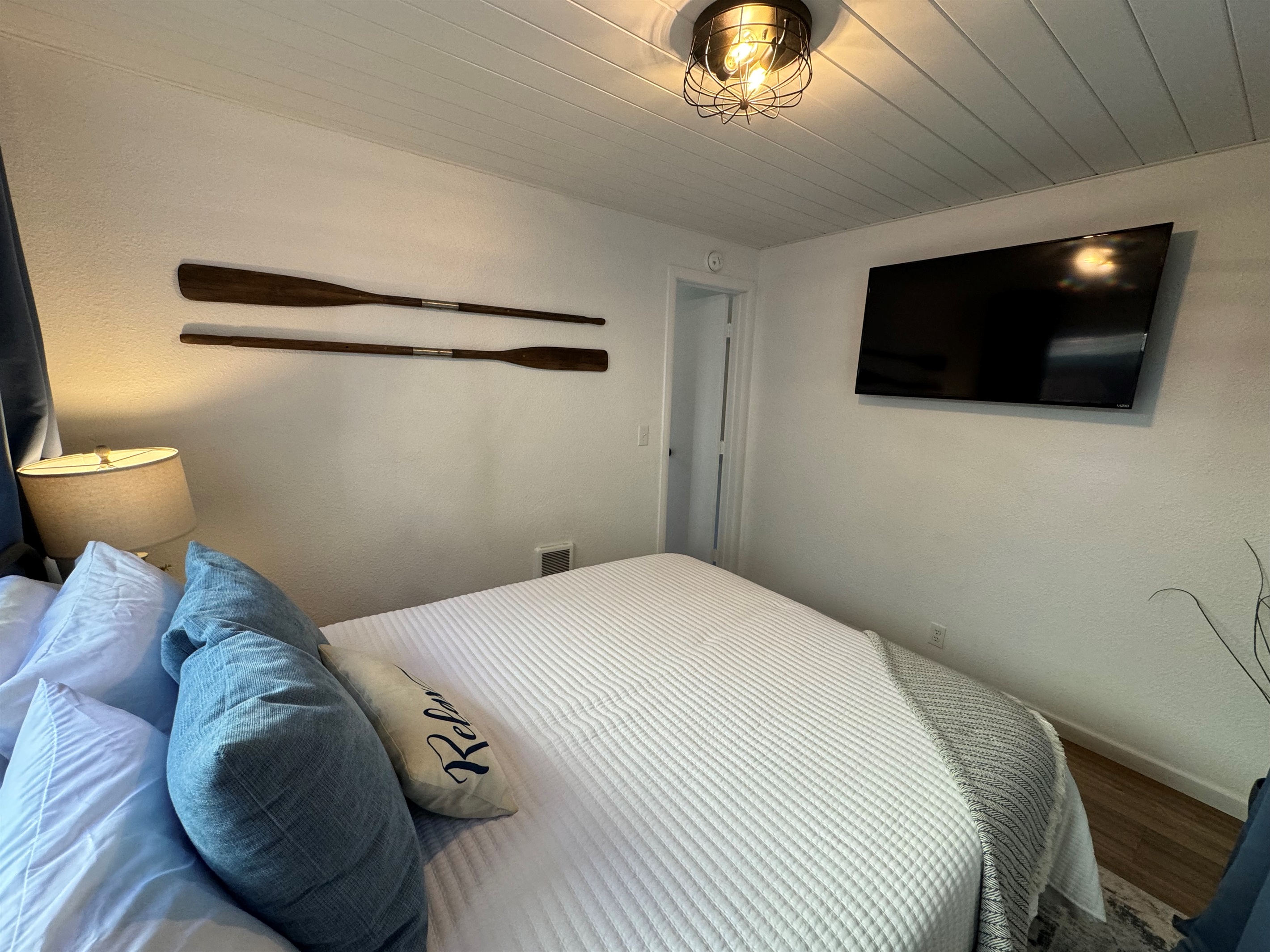 queen bedroom with its own TV