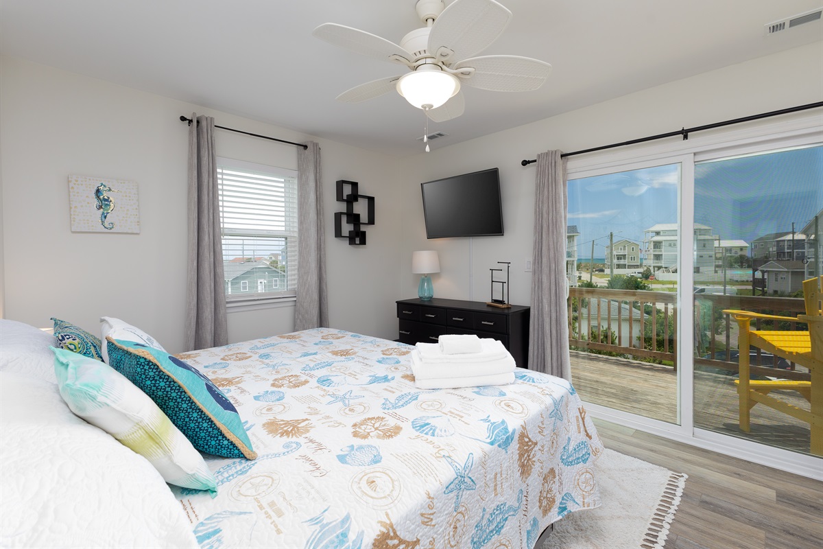 Master bedroom with balcony access and ocean views