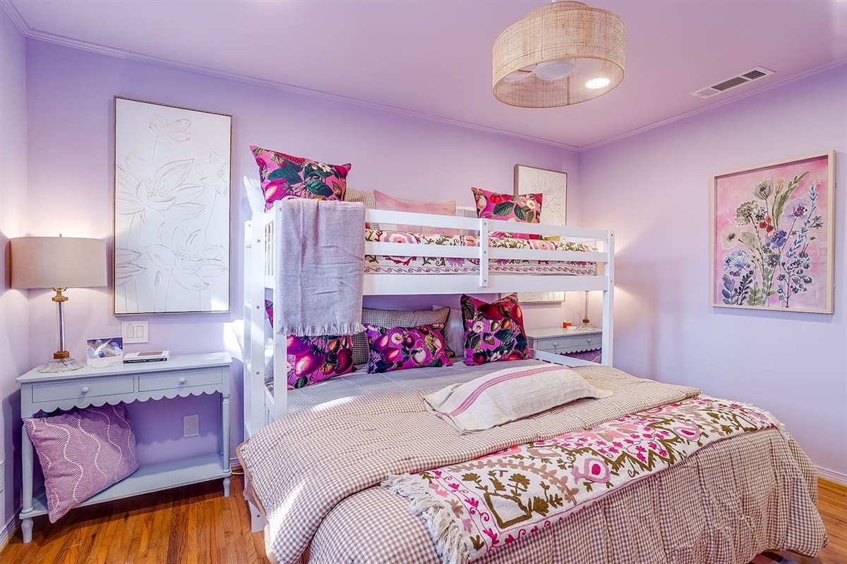 Bedroom Three: bold color, king bunk comfort, a breezy boho fan overhead, and enough pillows to make everyone claim top bunk.
