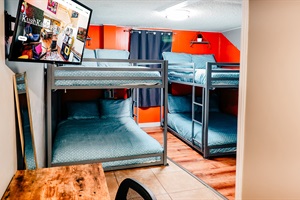 Bunk Bed Bliss: Twin Double Bunks in Cool Teal Beds with Sleek Gray Frames, Complete with TV Entertainment and Study Nook 🛏️📺📚