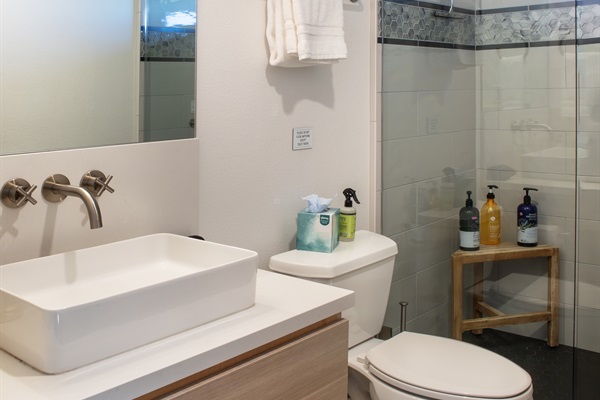 Modern fixtures, warm wood-look flooring, and a walk-in shower stocked with everything you need for the perfect refresh.