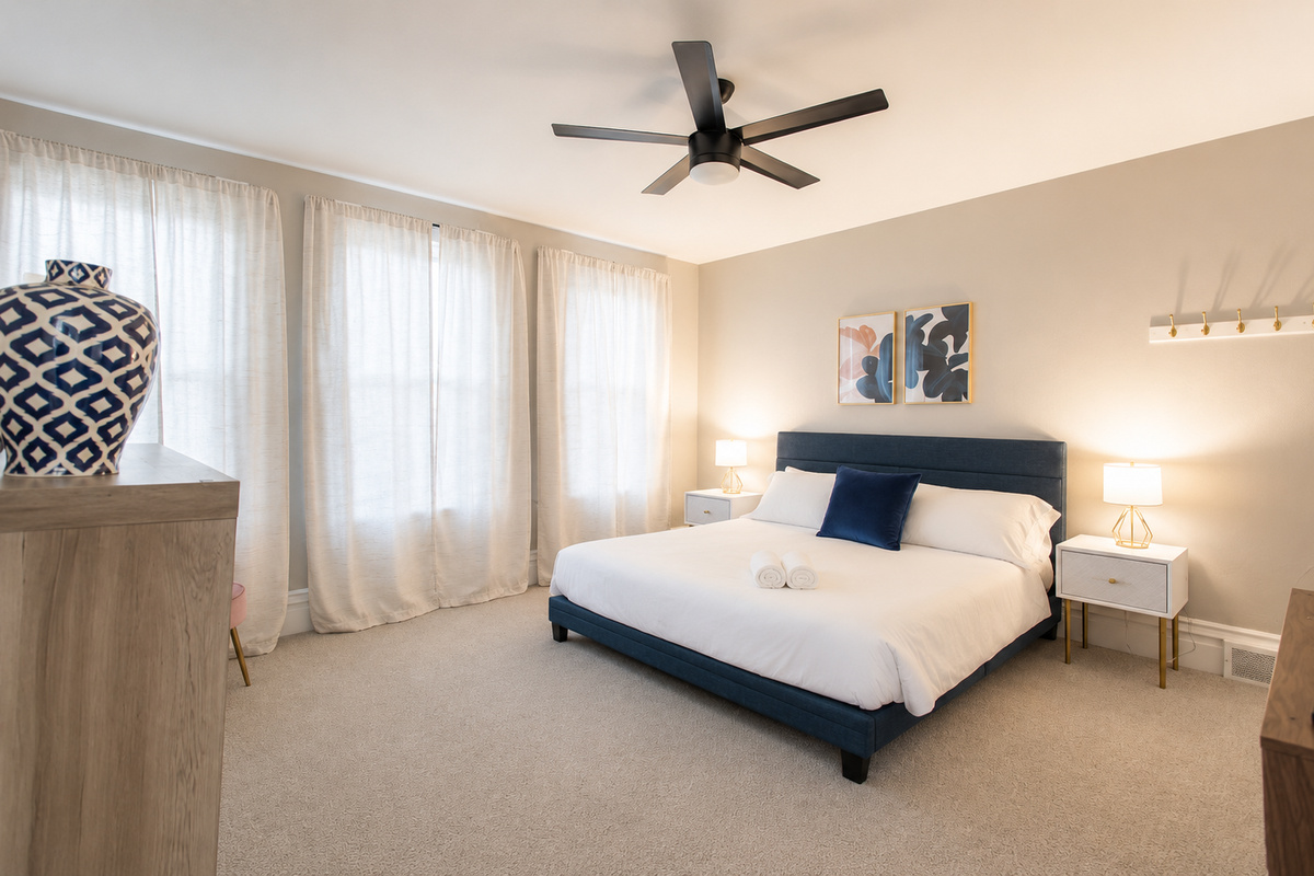 Discover the King Bedroom, a spacious room on the second floor with king bed flanked by nightstands with lamps.