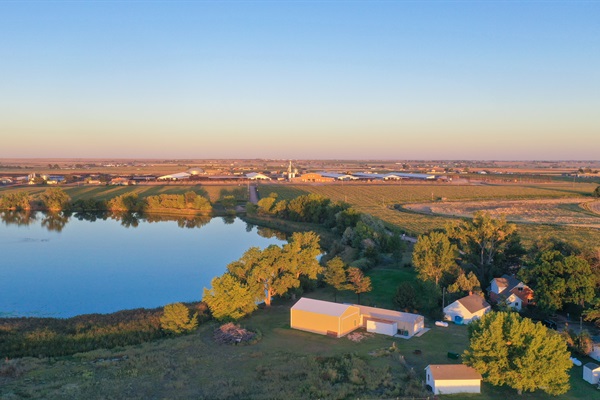 A bird’s-eye view of the property surrounded by lush fields, showcasing the charm of small-town Ault, Colorado.