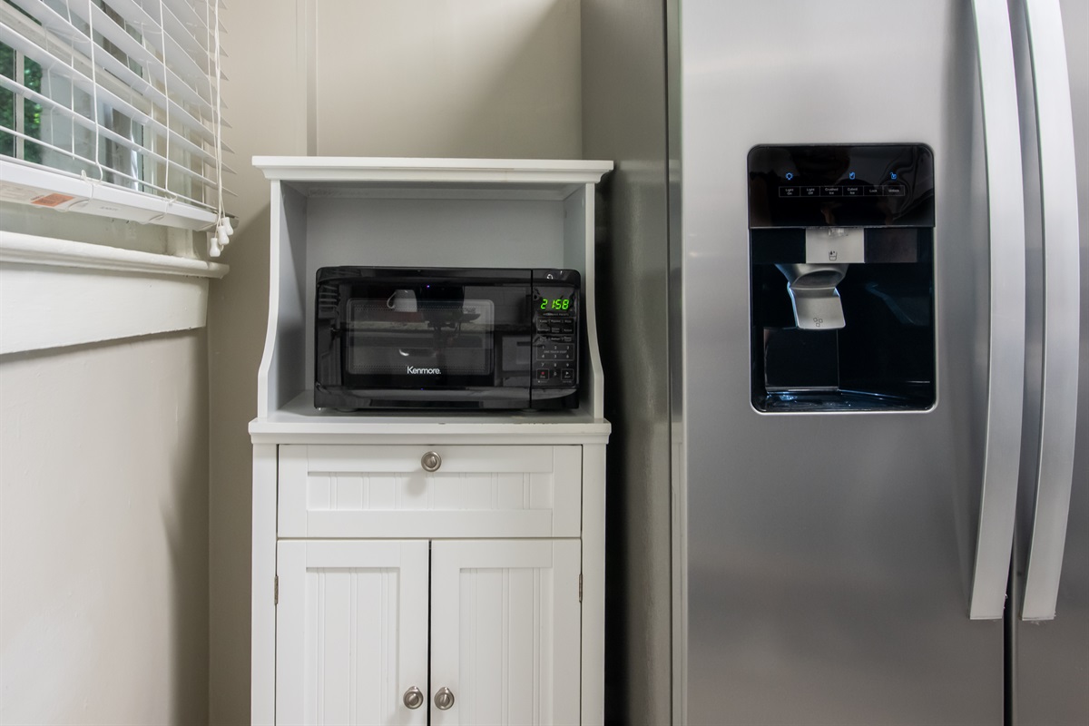 Modern kitchen essentials including a microwave and spacious fridge to store all your favorites.